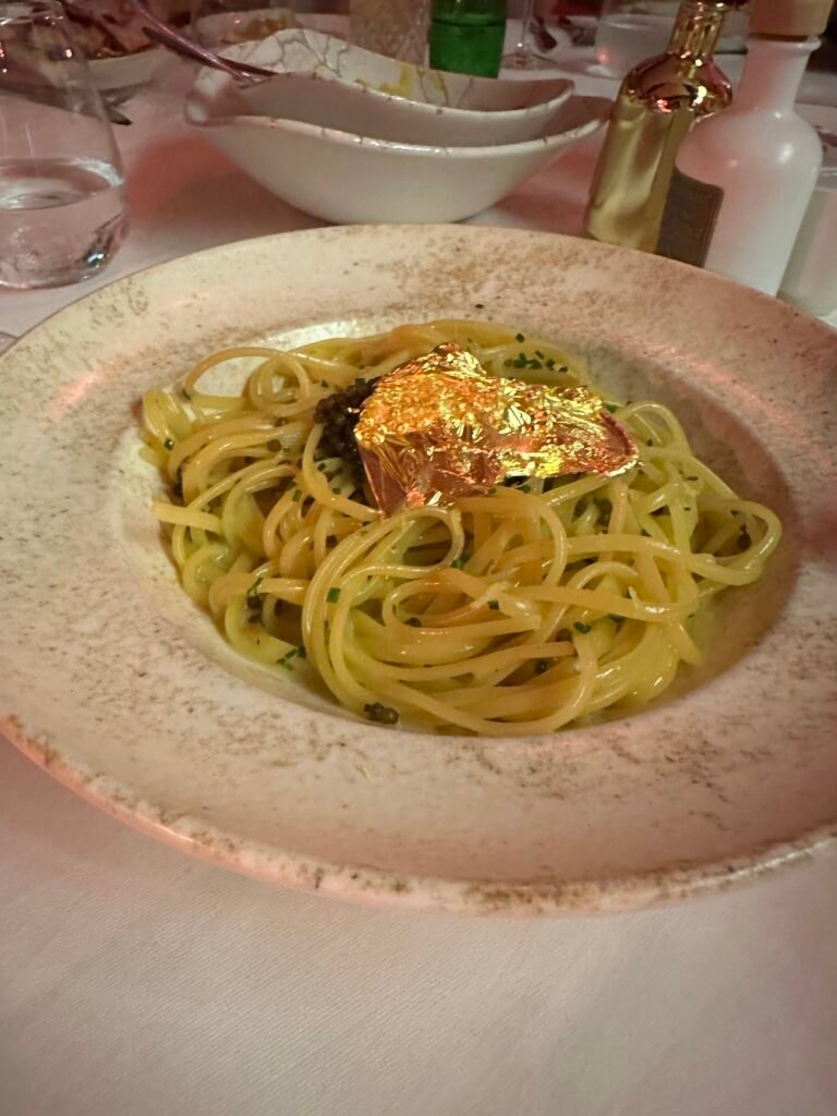 Golden flake caviar pasta dish at L’Opéra in Saint-Tropez, showcasing luxury French cuisine and glamorous presentation.