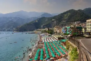 Panoramic view of Marina Grande in Sorrento with colorful fishing boats, seaside restaurants, and cliffs in the background