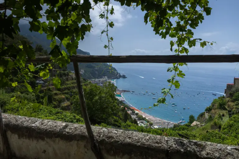 anoramic coastal views from the Path of Lemons trail, showcasing the dramatic cliffs, sparkling Mediterranean Sea, and colorful Amalfi Coast villages below.