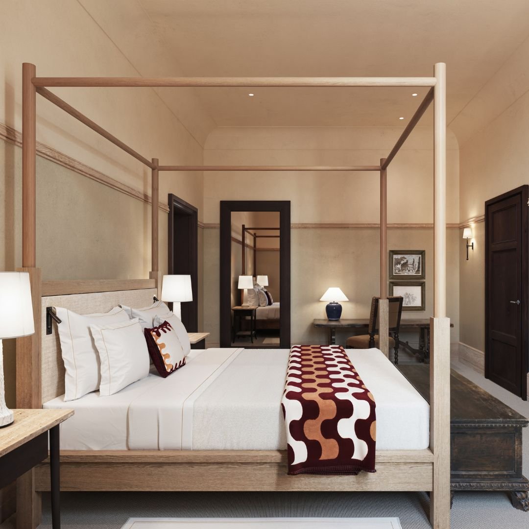 A master bedroom suite in a private apartment at La Réserve Firenze, showcasing neutral tones, natural stone details, and traditional Florentine architecture.