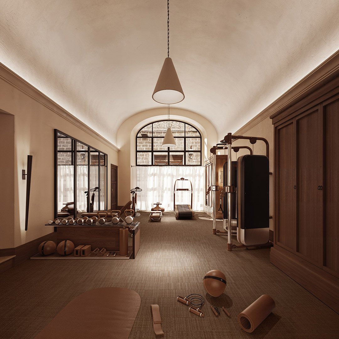 The private fitness studio at La Réserve Firenze featuring state-of-the-art Technogym and Woodway equipment for exclusive guest use.