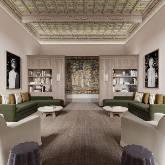 A spacious luxury living room at La Réserve Firenze featuring high ceilings, Siena travertine accents, and contemporary Italian furniture designed by Gilles & Boissier.