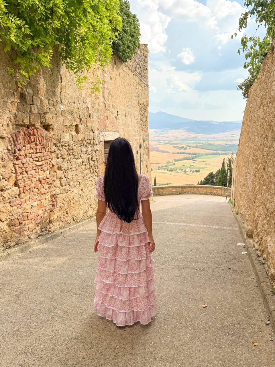 an influencer named Domenica Ida exploring Pienza, Tuscany